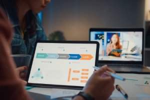 Web developer analyzing website analytics and performance on laptop
