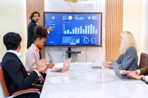 Social media marketing team planning content strategy around a conference table